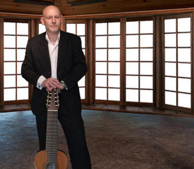 Jim - Guitarist Guitarist in empty room. He plays in Surrey and Berkshire