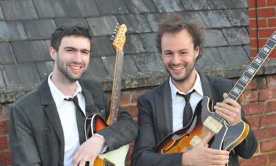 The LD Jazz Guitar Duo Jazz Duo in grey suits. They play in Oxfordshire, Hampshire, Kent and Northha