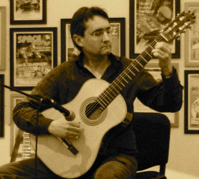 Roberto - guitarist Classical Guitarist concentrates as he plays in London and Middlesex